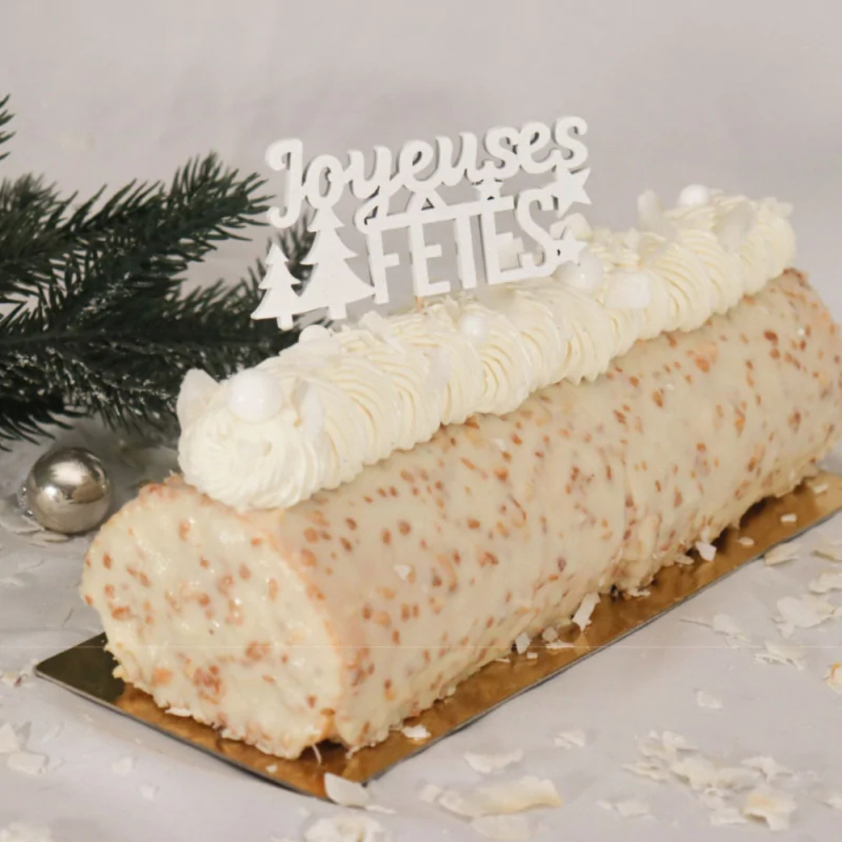 Lot de 2 décors sur pique blancs « Joyeuses Fêtes » Patis'Décor de 9 cm, avec motifs de sapins et d'étoiles, présentés dans leur emballage.